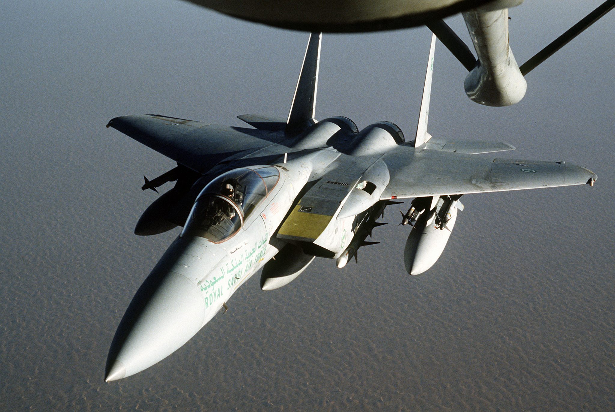 A Royal Saudi Air Force F-15 Eagle fighter aircraft approaches a KC-135 Stratotanker from the 1700th Air Refueling Squadron Provisional for refueling during Operation Desert Shield.